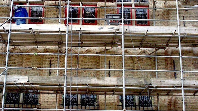 An image of historic fenestration behind scaffolding
